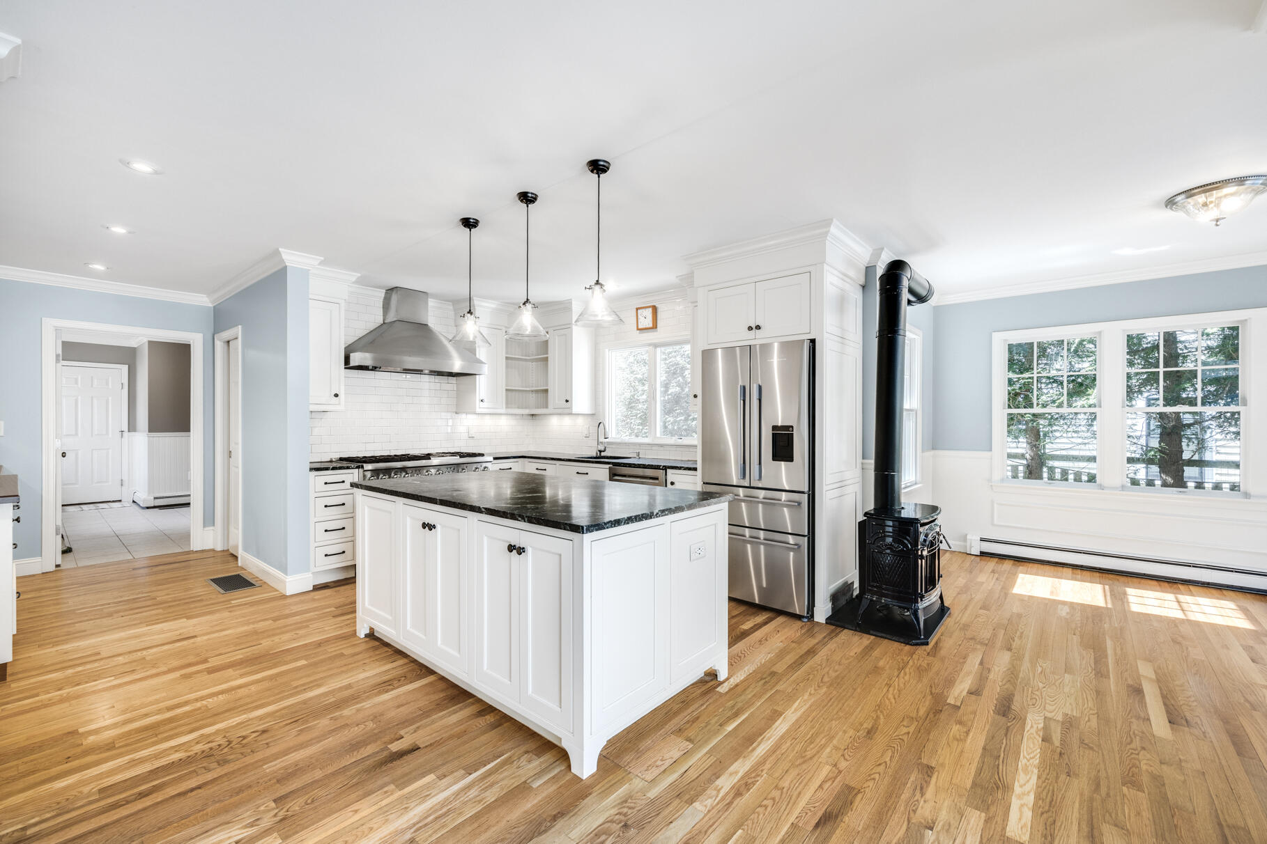 25 Blanid Road Osterville, MA 02655 - Photo 9 of 27 a kitchen with stainless steel appliances a refrigerator a sink dishwasher a stove and white cabinets with wooden floor