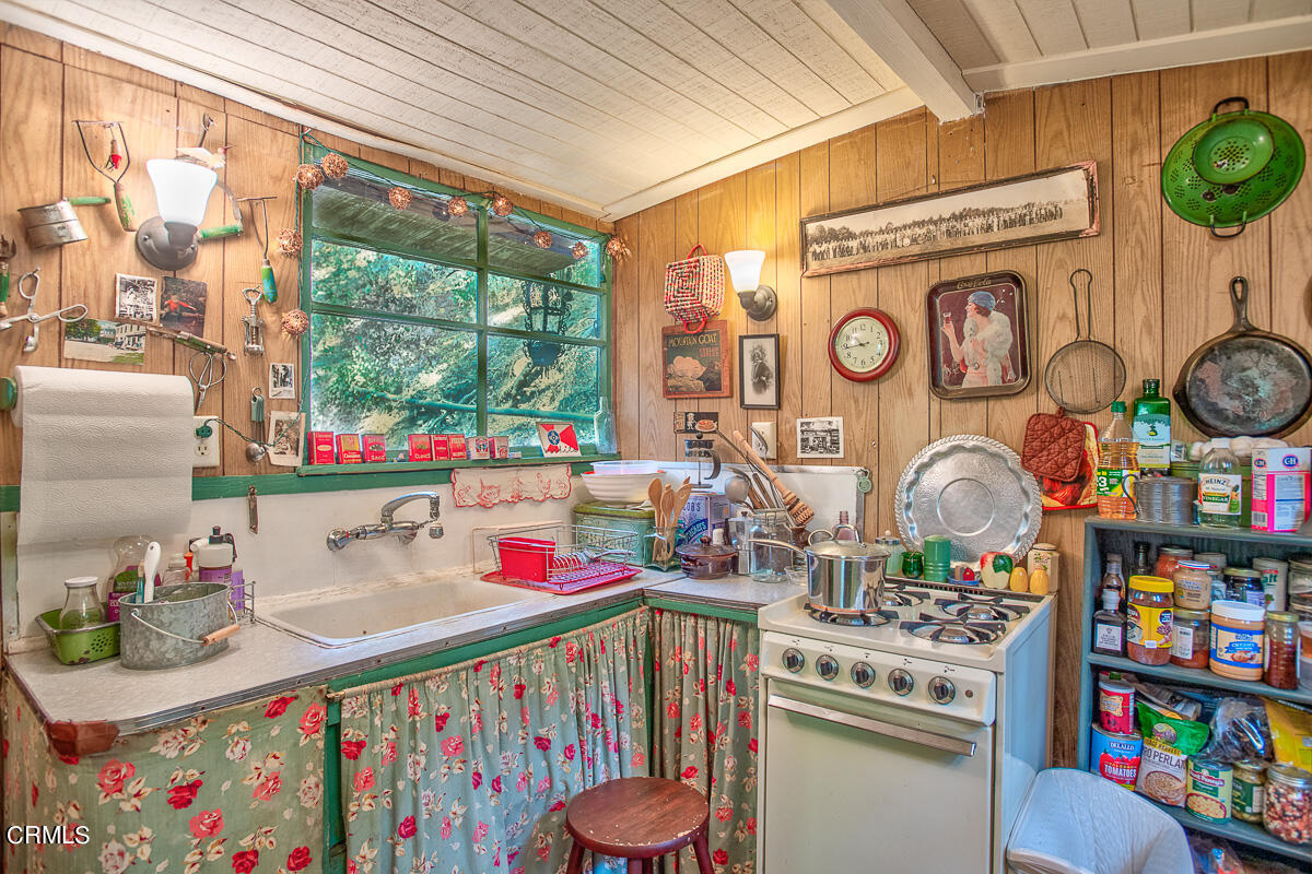 Undisclosed Address Altadena, CA 91001 - Photo 11 of 23 a utility room with stainless steel appliances lots of clutter and cabinets