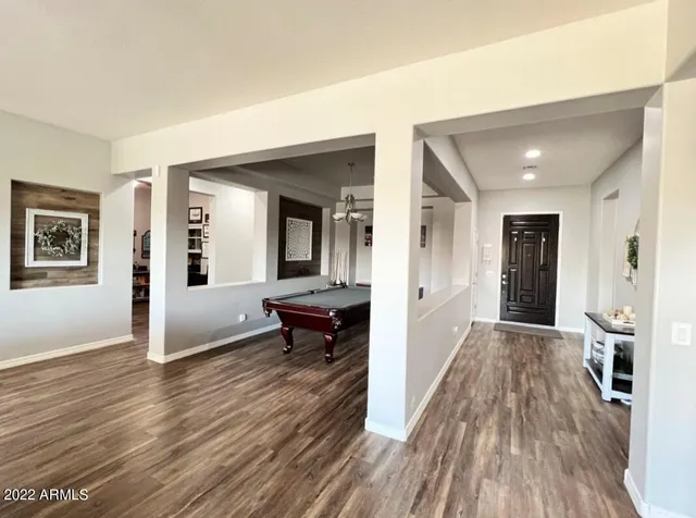 a view of a hallway view with wooden floor and furniture