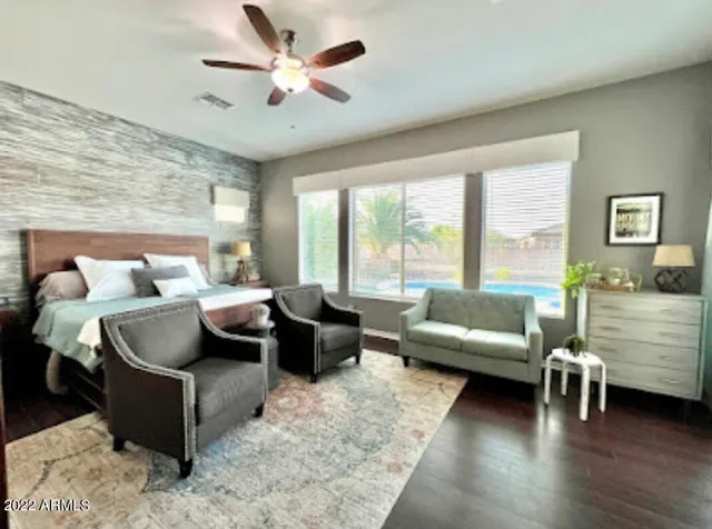 a living room with furniture and floor to ceiling windows