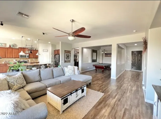 a kitchen with stainless steel appliances granite countertop a stove and a bookshelf