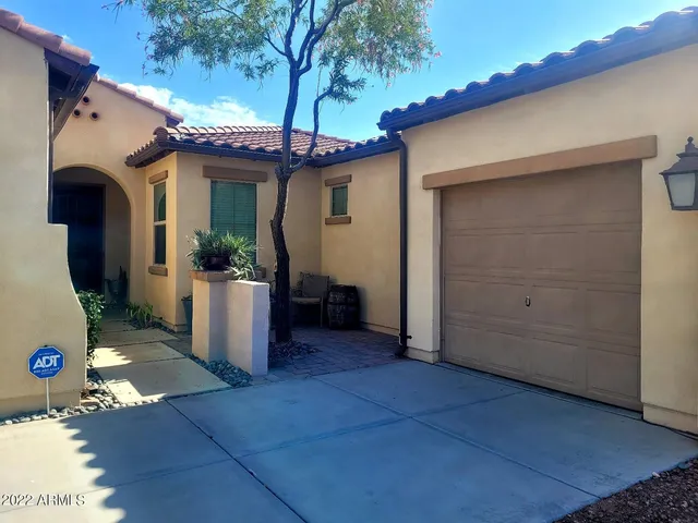 a view of a house with a potted plant and a chair