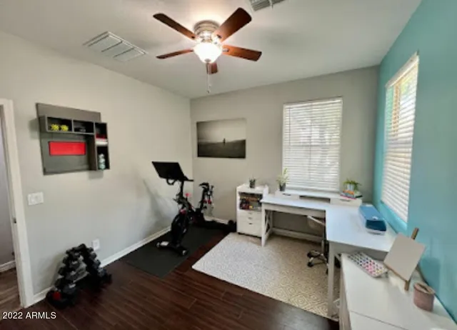 a view of a patio with a table and chairs under an umbrella