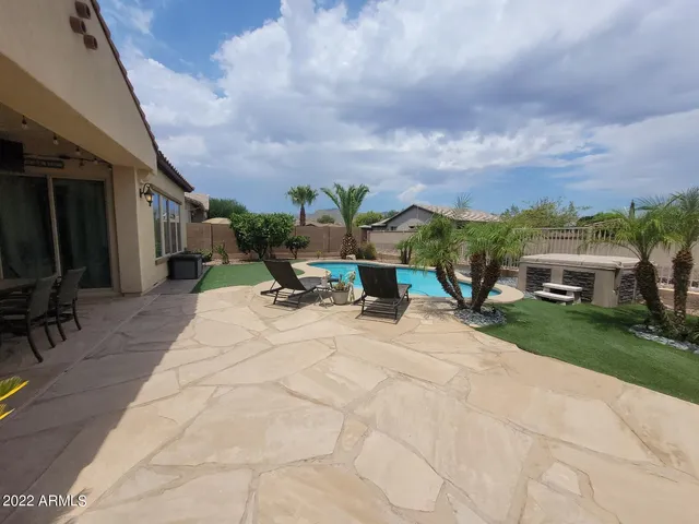 a view of a patio with a table and chairs