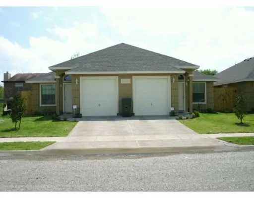 a view of backyard of house and garage