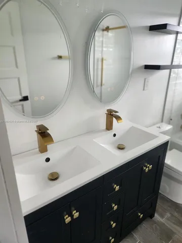 a bathroom with a double vanity sink and mirror