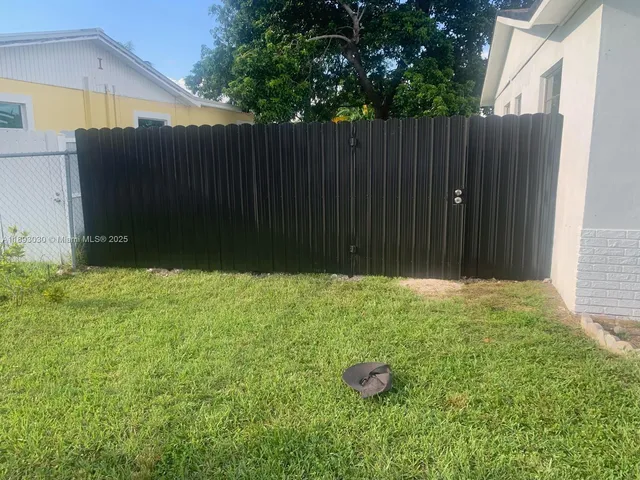a view of outdoor space with wooden fence