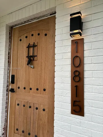 a view of a entryway door with wooden floor