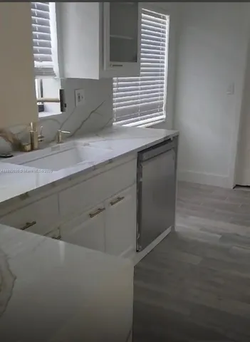 a kitchen with a sink and cabinets
