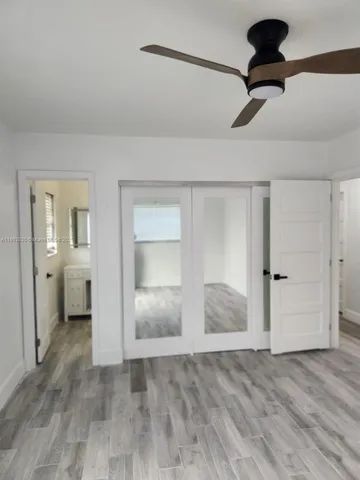 a view of a room with a barbeque and wooden floor