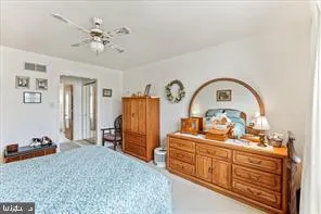 a bedroom with furniture and mirror