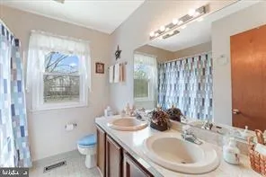 a bathroom with a sink a toilet and a mirror