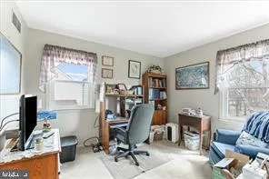a view of a workspace with furniture and a window