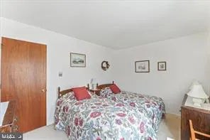 a bedroom with a bed and a lamp