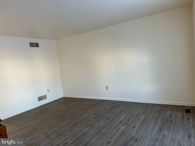 an empty room with wooden floor