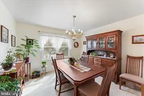 a view of a dining room with furniture and a chandelier
