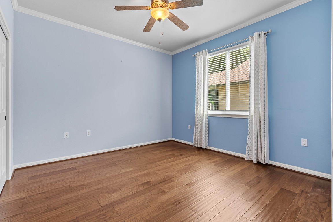 409 Rio Grande Loop Georgetown, TX 78633 - Photo 15 of 38 wooden floor in an empty room with a window