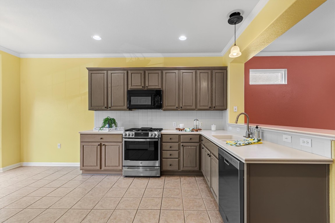 409 Rio Grande Loop Georgetown, TX 78633 - Photo 19 of 38 a kitchen with stainless steel appliances granite countertop a sink and cabinets