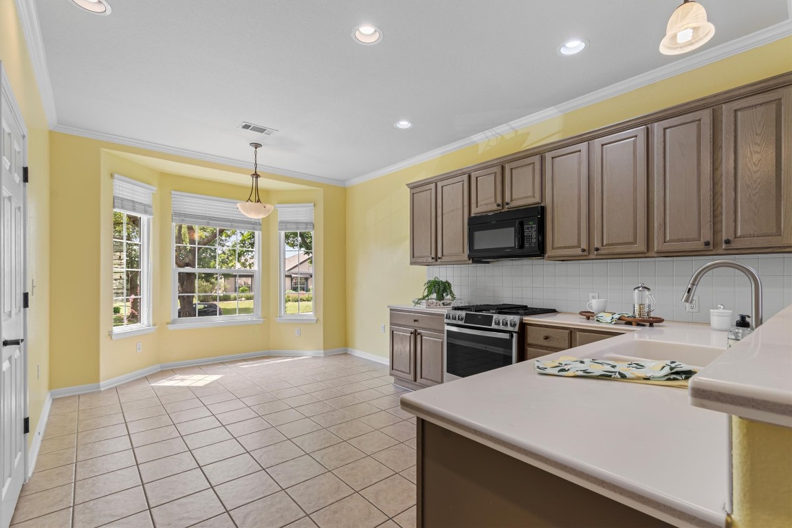 409 Rio Grande Loop Georgetown, TX 78633 - Photo 20 of 38 a kitchen with stainless steel appliances a stove sink microwave and cabinets