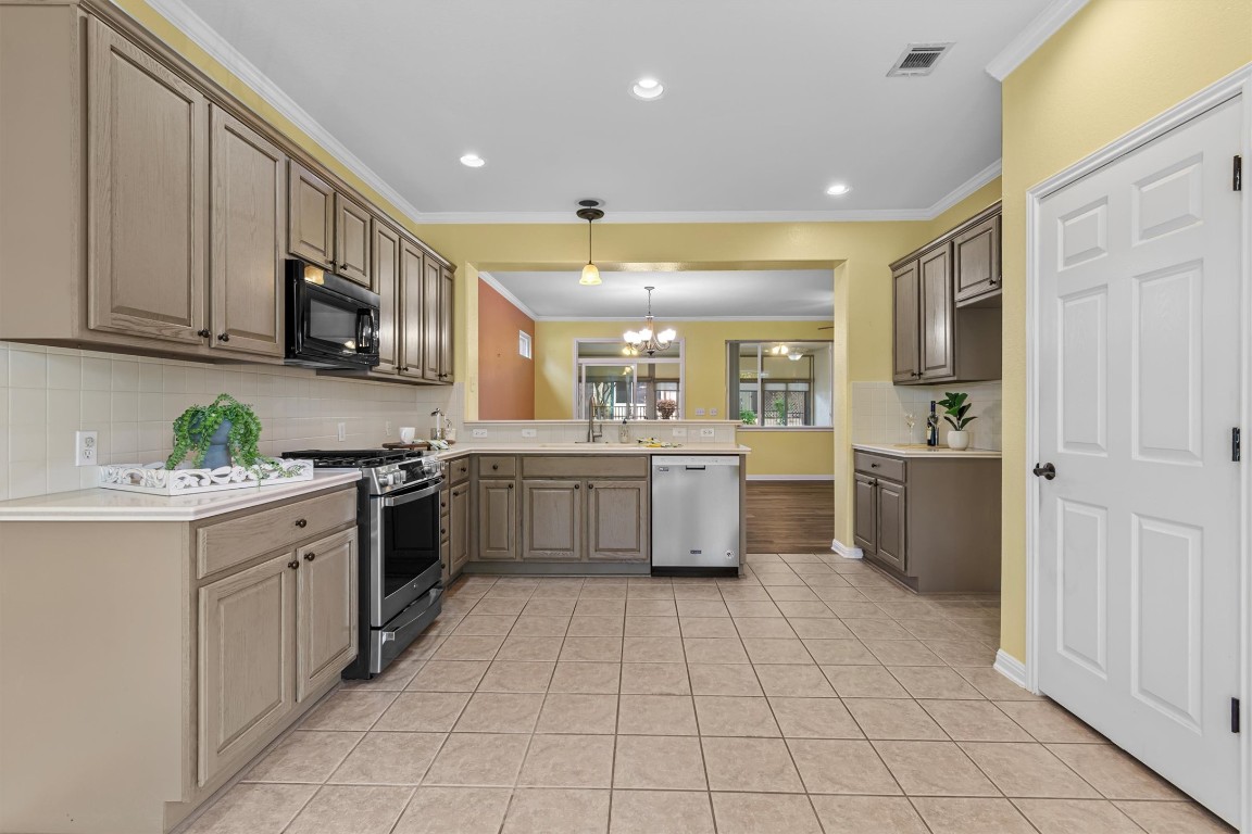 409 Rio Grande Loop Georgetown, TX 78633 - Photo 21 of 38 a kitchen with a sink a stove top oven and cabinets
