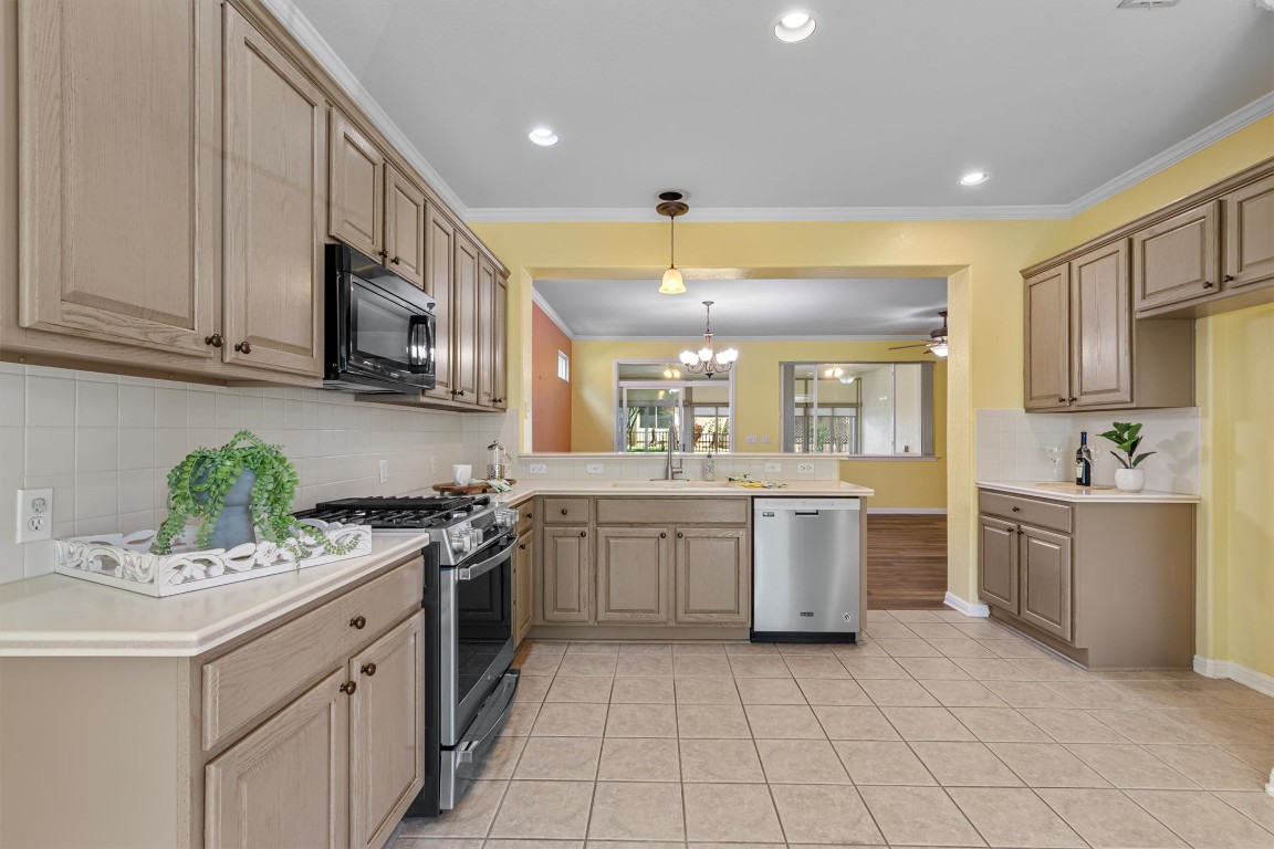 409 Rio Grande Loop Georgetown, TX 78633 - Photo 22 of 38 a kitchen with a sink stove and cabinets