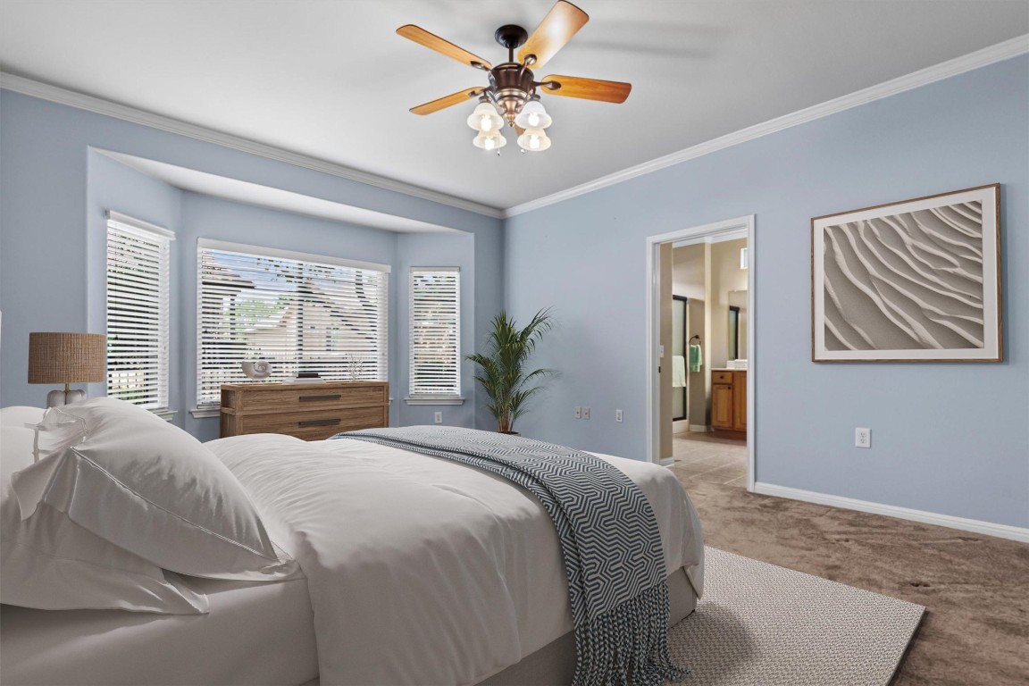 409 Rio Grande Loop Georgetown, TX 78633 - Photo 10 of 38 a bedroom with a large bed and a chandelier