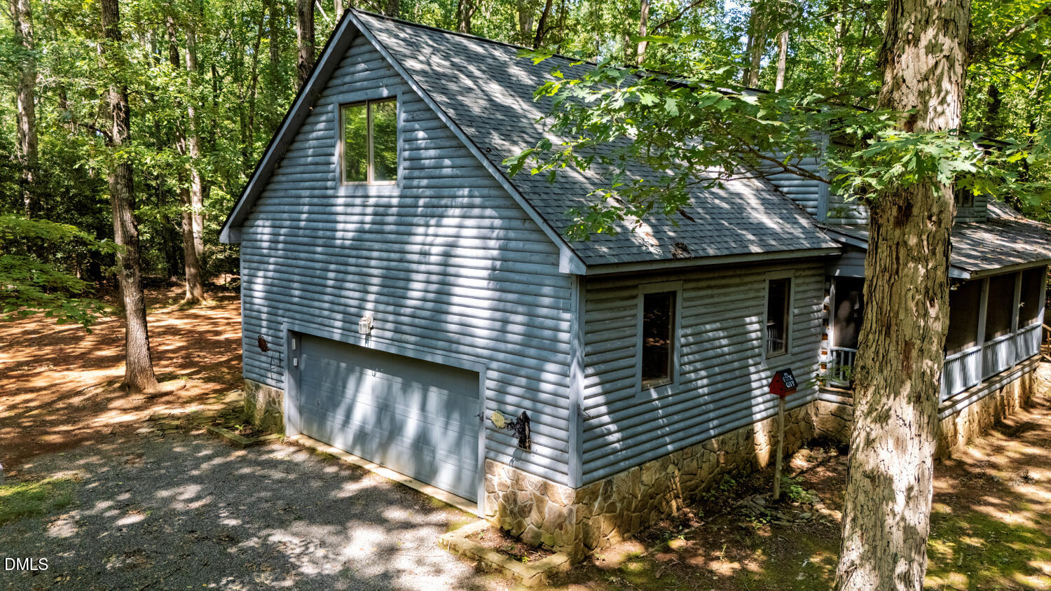 7391 Howerton Road Elon, NC 27244 - Photo 47 of 53 Wood-sided exterior with a natural stone foundation, two-car garage, and a screened porch