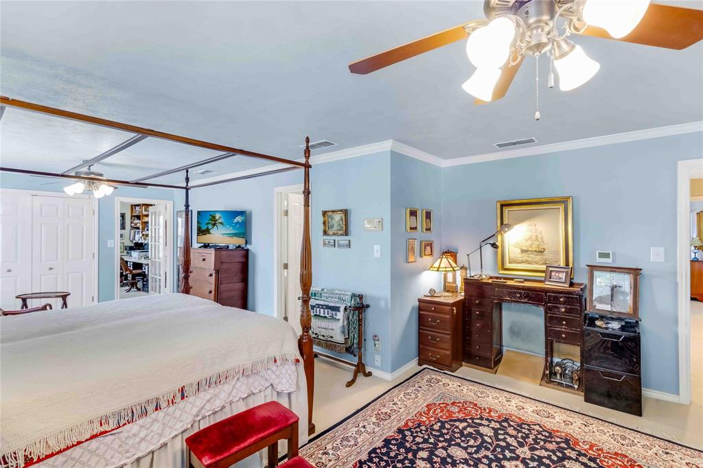 216 McMillen Road Lucas, TX 75002 - Photo 26 of 36 a bedroom with a bed and a chandelier