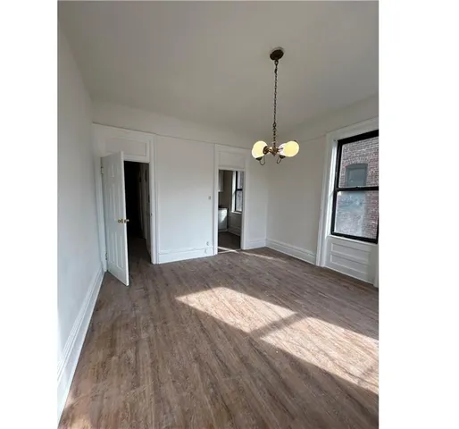 a view of an empty room with a kitchen