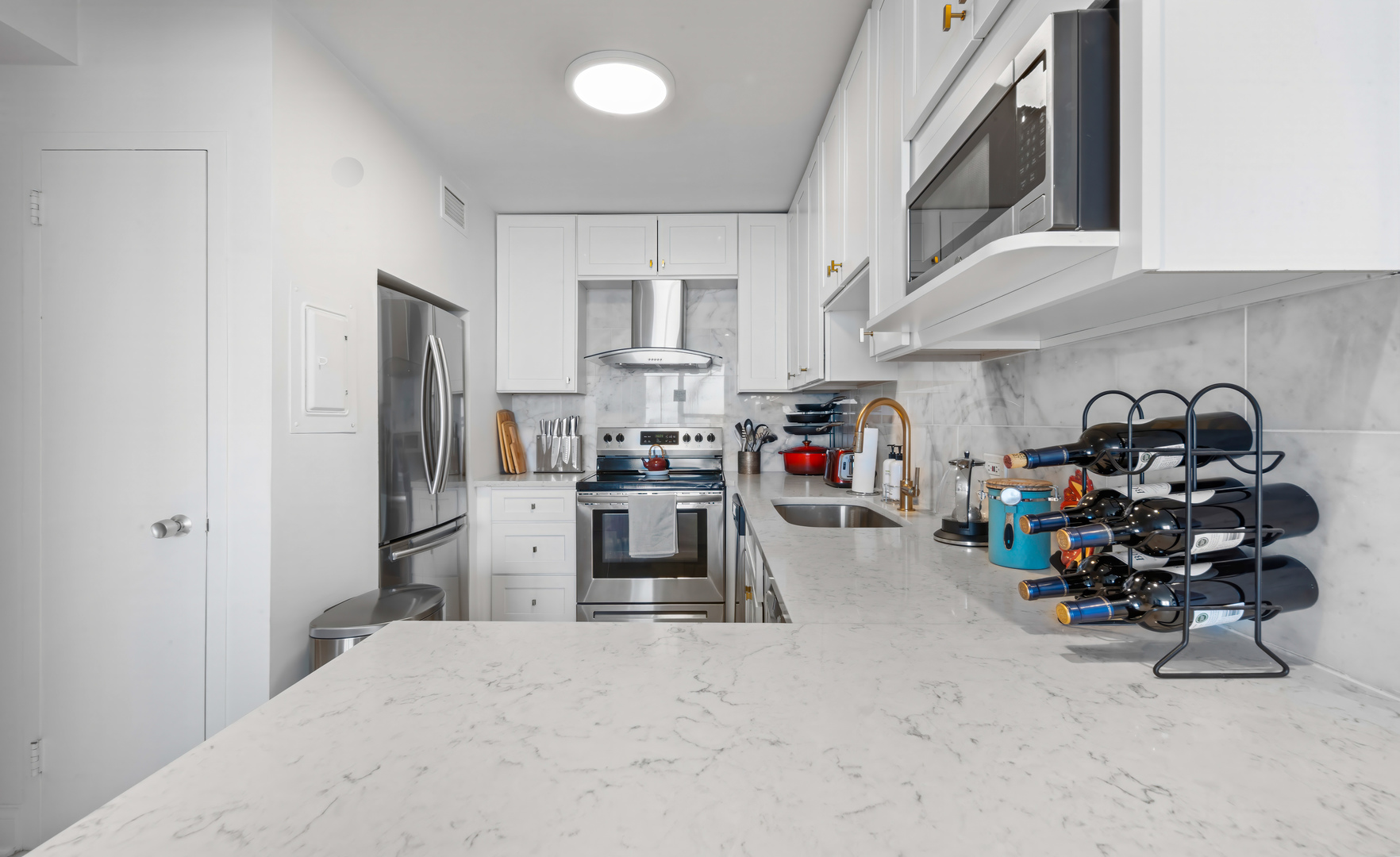 1550 North Lake Shore Drive, Unit 25E Chicago, IL 60610 - Photo 6 of 13 a kitchen that has a lot of appliances a sink and cabinets