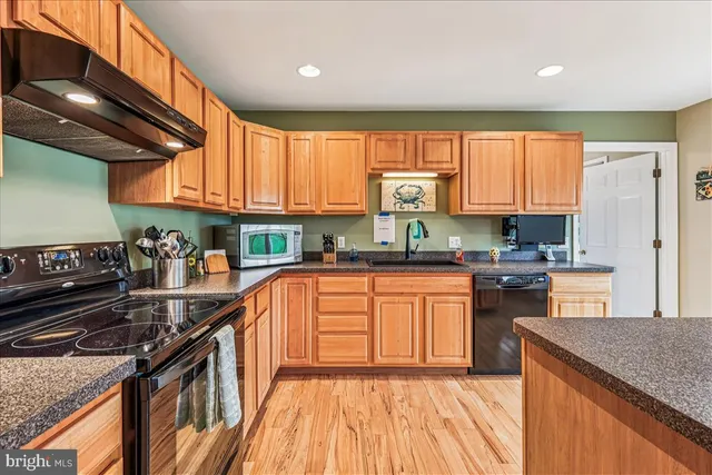 a kitchen with large windows and refrigerator