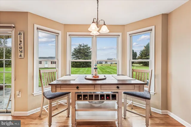 a view of a dining room with furniture large windows and wooden floor