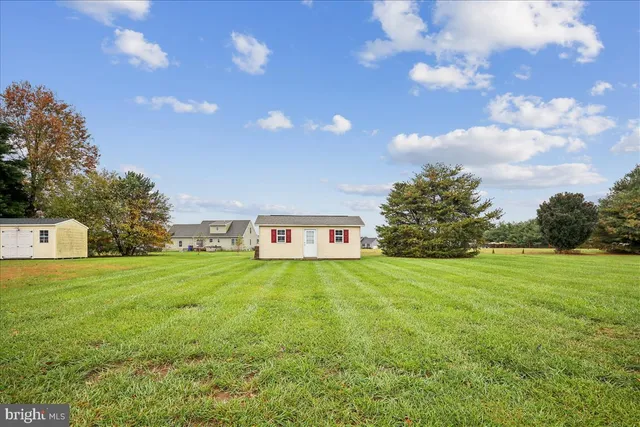 a view of large house with a big yard and large trees