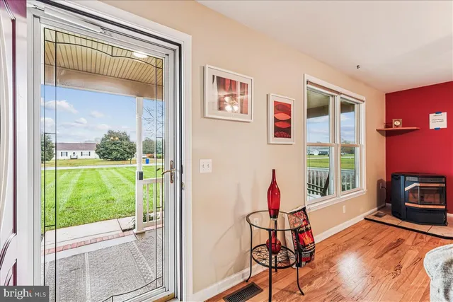 a living room with furniture a flat screen tv and gym equipment
