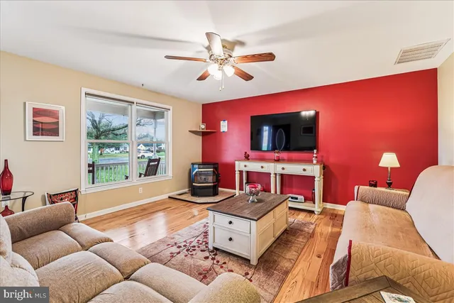 a kitchen with stainless steel appliances granite countertop wooden floor dining table and chairs