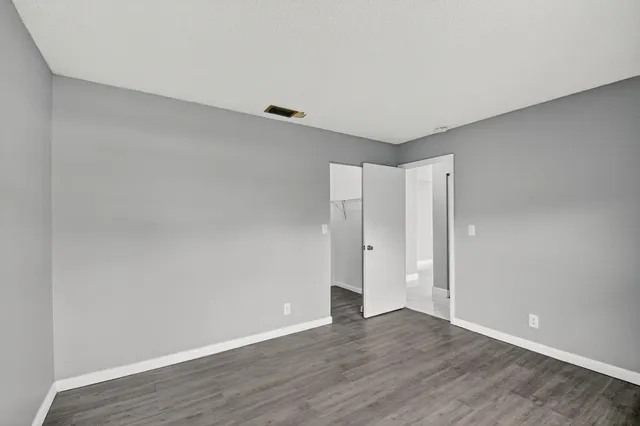 a view of an empty room and wooden floor
