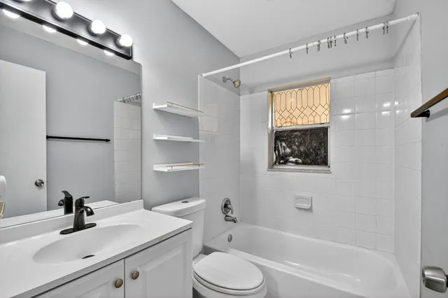 a bathroom with a sink toilet tub and shower