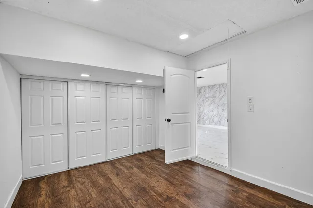 a view of an empty room and closet area