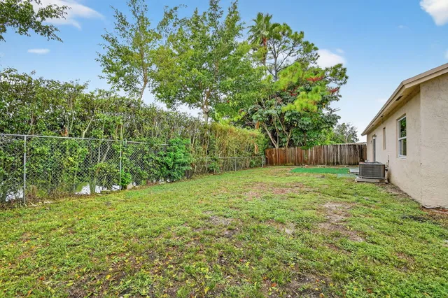 a view of a backyard with large trees