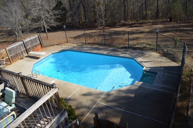199 Orchard Ridge Drive Forsyth, GA 31029 - Photo 17 of 21 a view of a roof deck with couches and wooden fence