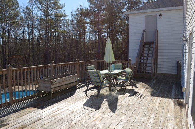 199 Orchard Ridge Drive Forsyth, GA 31029 - Photo 18 of 21 a view of balcony with chairs and wooden fence