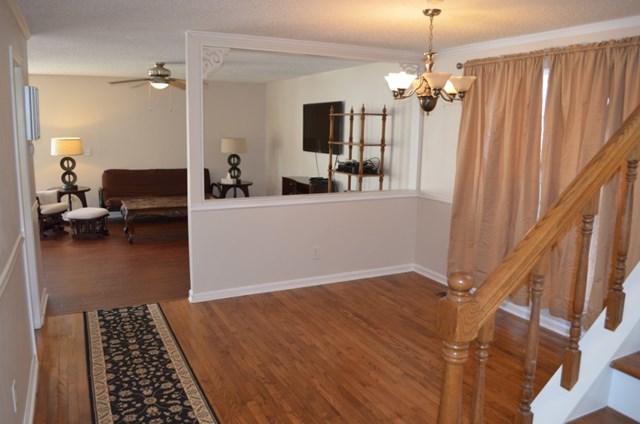 199 Orchard Ridge Drive Forsyth, GA 31029 - Photo 3 of 21 a view of a livingroom with furniture wooden floor and a chandelier
