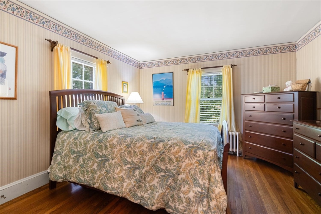 114 South Border Road Medford, MA 02155 - Photo 22 of 36 a bedroom with a bed and wooden floor