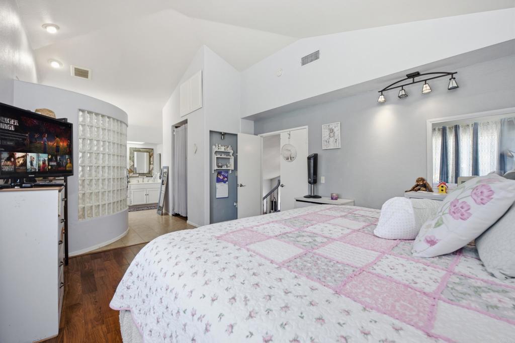 2077 Westwood Road Vista, CA 92083 - Photo 20 of 37 a bedroom with a bed and a large mirror