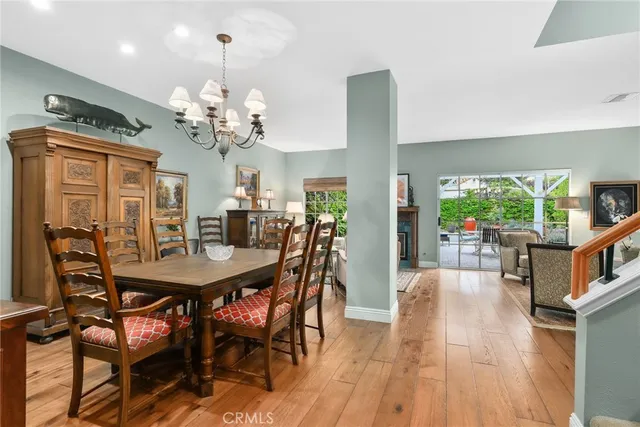 a view of a dining room with furniture and a chandelier