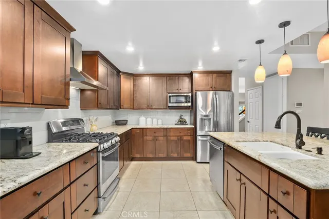 a kitchen with granite countertop a sink stove and cabinets