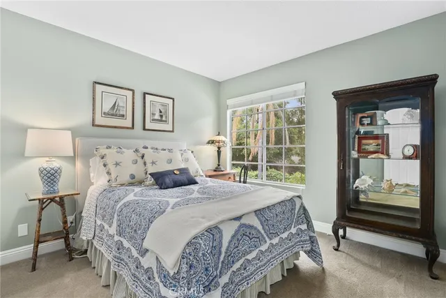 a bedroom with double bed and next to a window