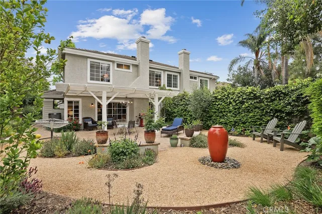 a view of a patio with a table and chairs next to a yard