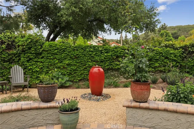 a park bench sitting in the middle of a park with large trees