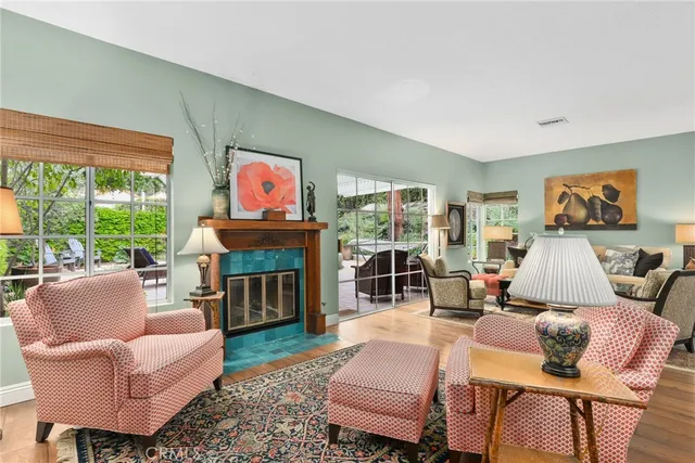 a living room with fireplace furniture and a large window